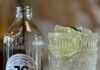 Jackworth Ginger Beer Brewery Now Open in Larimer An empty bottle with a Jackworth Ginger Beer label on it next to a clear cocktail with a lime wedge.