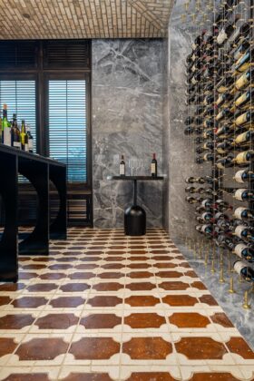 Marble wall with wine rack, marble floor and other stone features by Armina Stone at the Fawn & Fable restaurant and Nemacolin.