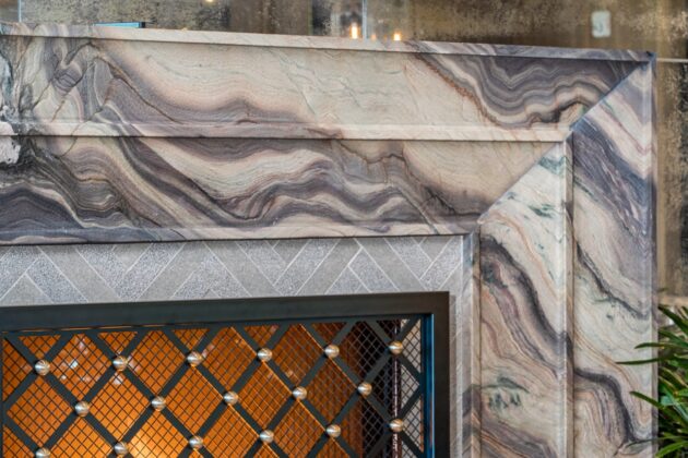 A closeup of the right edge of a marble fireplace by Armina Stone at Nemacolin.