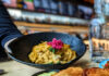 Pisco & Lime, A Peruvian Pop-Up in City Kitchen A plate of Peruvian food on a table with someone reaching for it