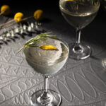 A clear cocktail in a martini glass