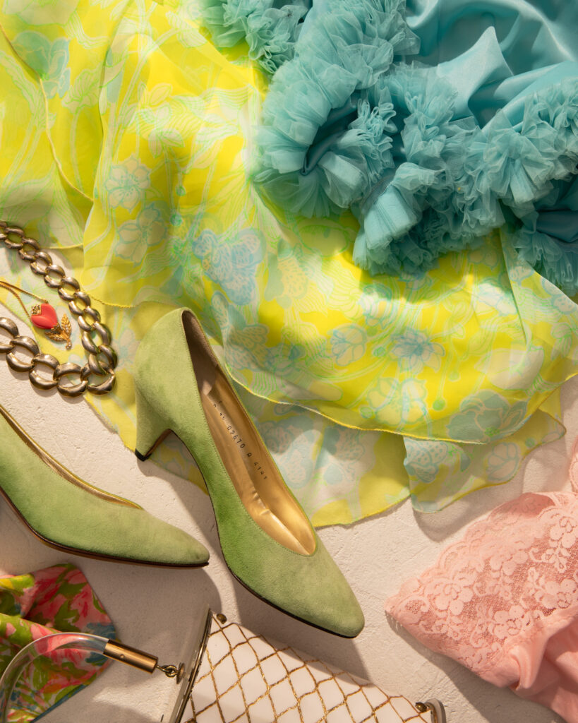 A photo of fluffy vintage dresses and green shoes from one of Pittsburgh's vintage shops.