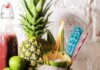 Best Places for Mocktails in Pittsburgh A skull mocktail glass at Hidden Harbor in Pittsburgh has a flame shooting out of a coconut shell with a pineapple and limes in the background.