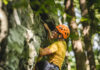 11 Activities to Get Outdoors Near Pittsburgh A man climbing a mountain outdoors with all the essential gear on.