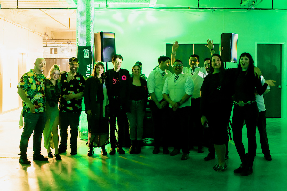 A group of mixologists in a green lit room at TABLE Magazine's cocktail shakeoff 