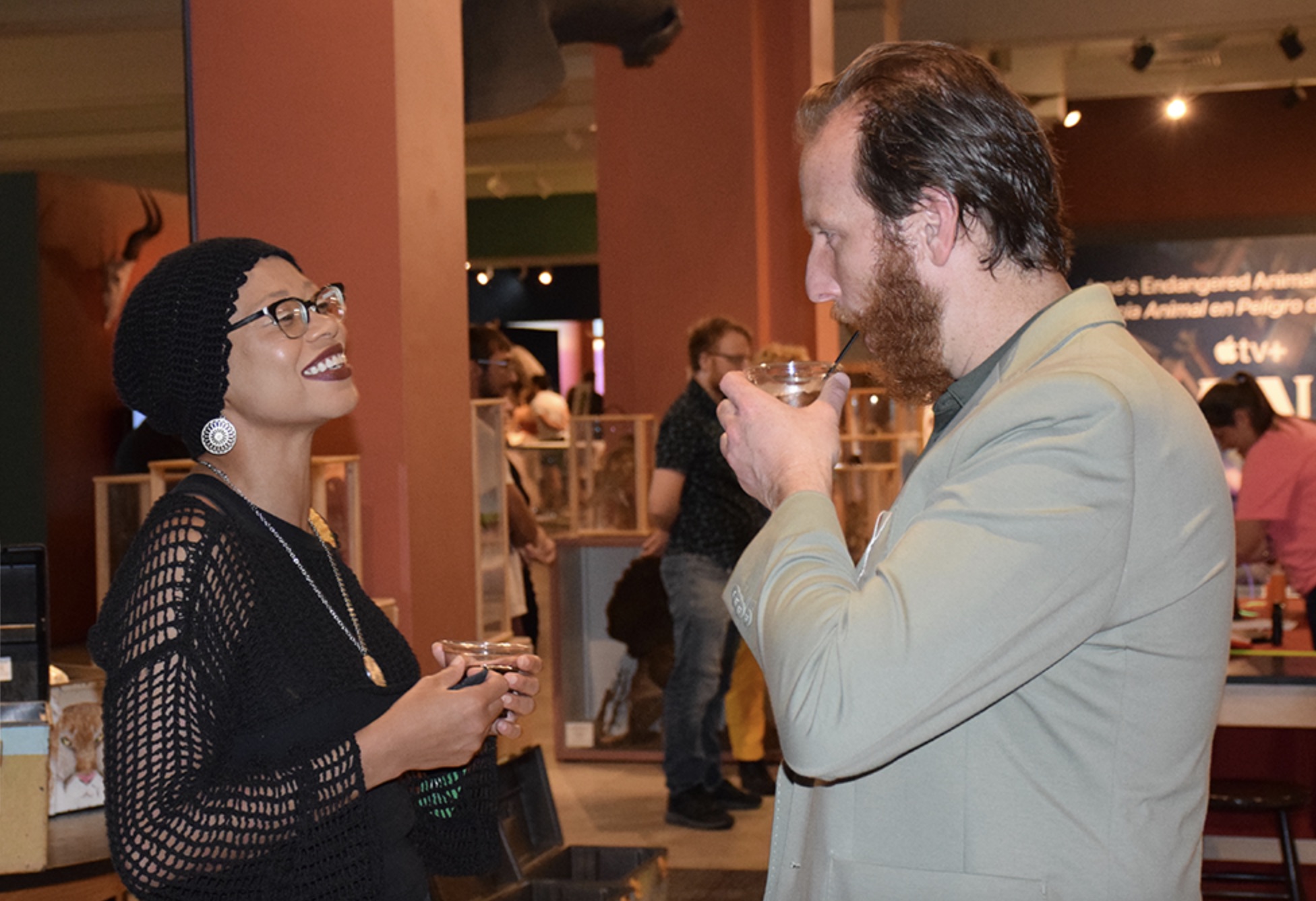 Two people sip cocktails inside the Carnegie Natural History Museum in Pittsburgh.