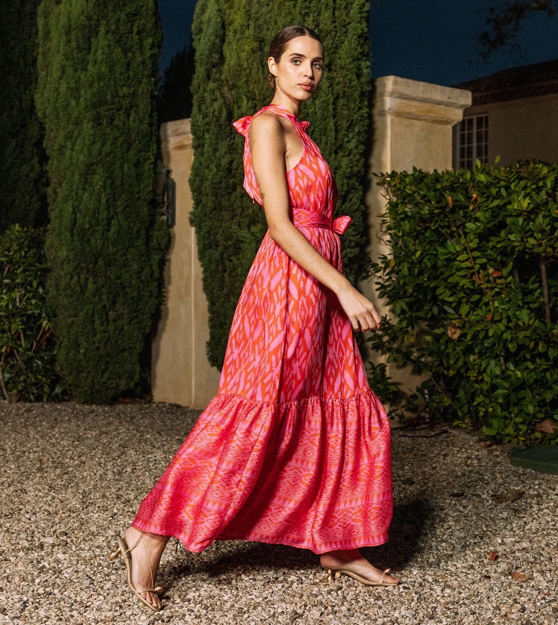 A woman walks in a long pink dress from a local Pittsburgh store.