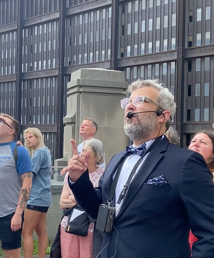 Mark Houser leads a Pittsburgh skyscraper tour with the U.S. Steel building behind him