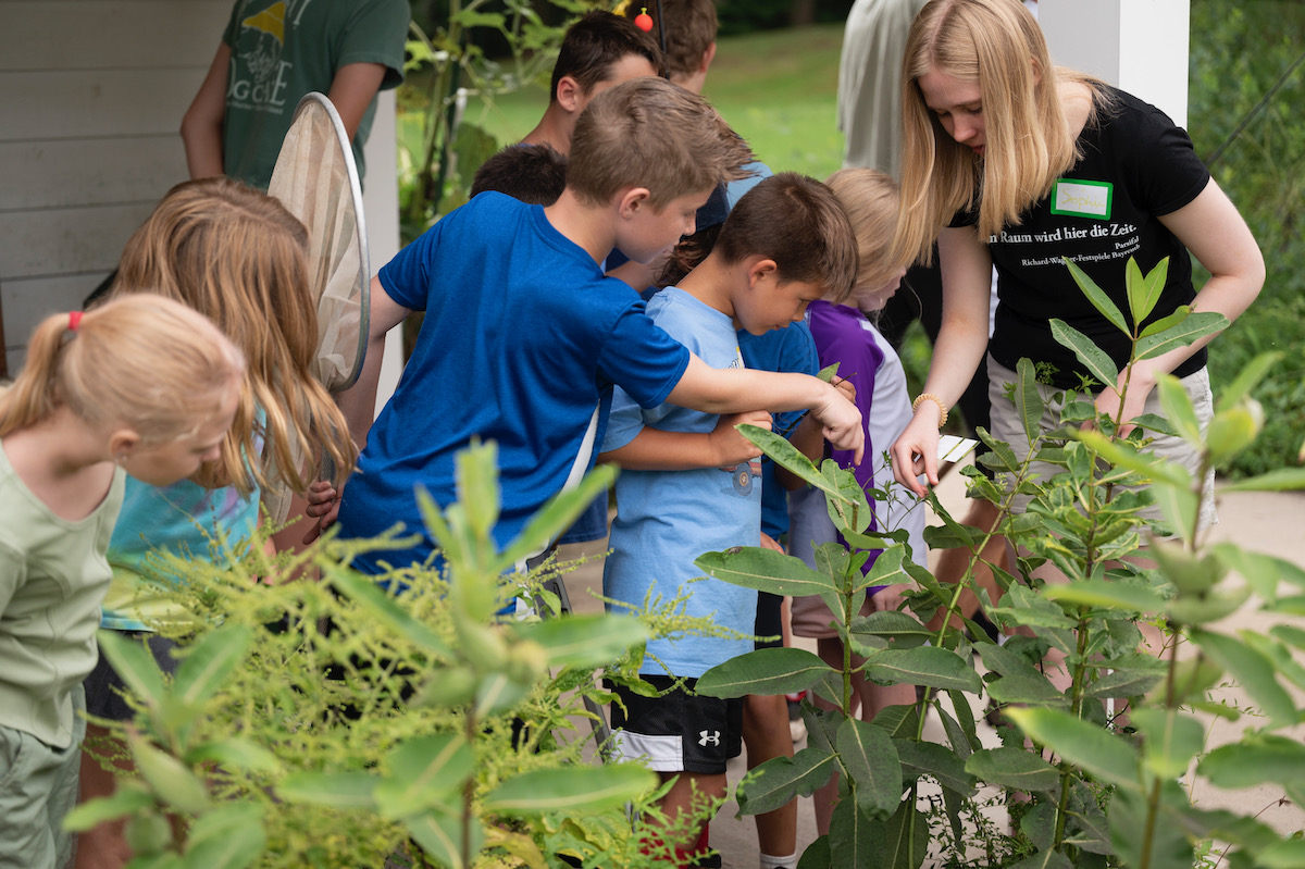 A group of children look at plants together