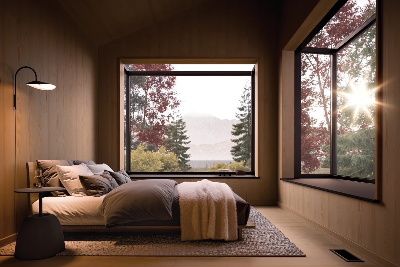 A neutral brown toned bedroom and backsplash sits around open windows revealing the forest. 