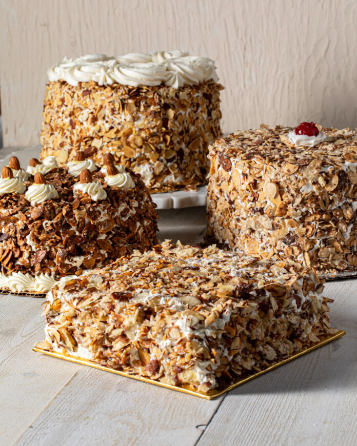 A burnt almond torte on a white background