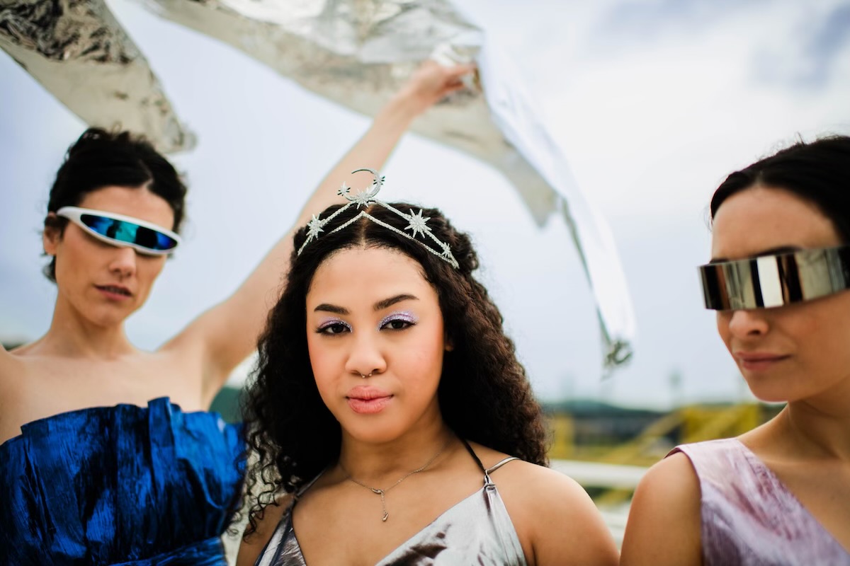 Three women dressed in galactic themed attire for Riverlife's Party at the Pier: Galactic.