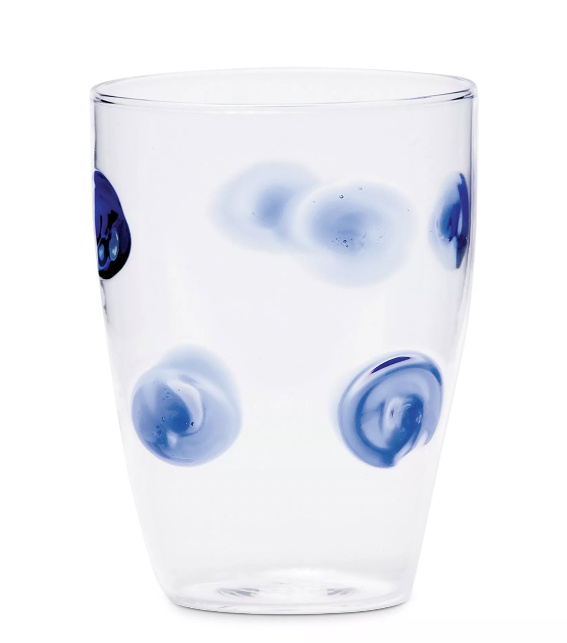 A white glass with blue painted dots sits against a white background.