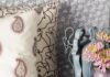 Opulent Nostalgia Takes Over Design Trends in 2025 A paisley nostalgia pillow sits beside two funky, bright colored vases.