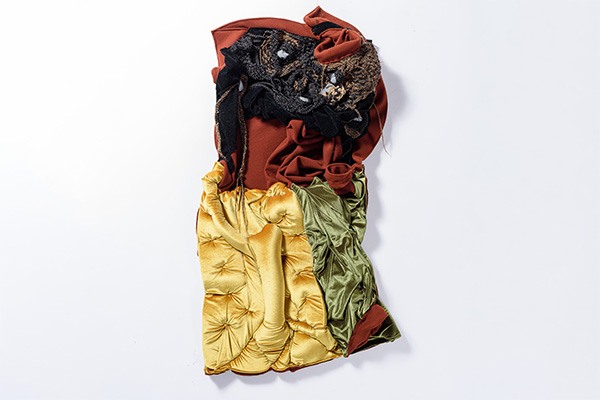 A work by Akudzwe Elsie Chiwa with velvet in yellow, dark earth tones, green, and black