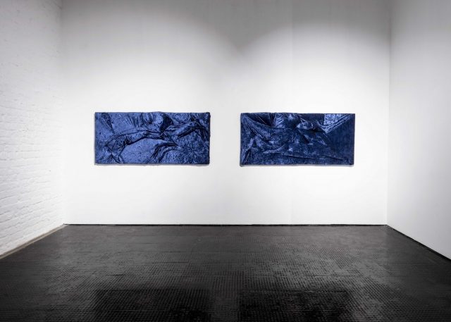 Two dark blue velvet pieces on a white background at an art gallery in Cape Town