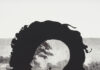 Kara Walker Comes to the Frick Pittsburgh in 2025 A Kara Walker painting with a silhouette transposed over an image from Civil War history, a face cut out of its center