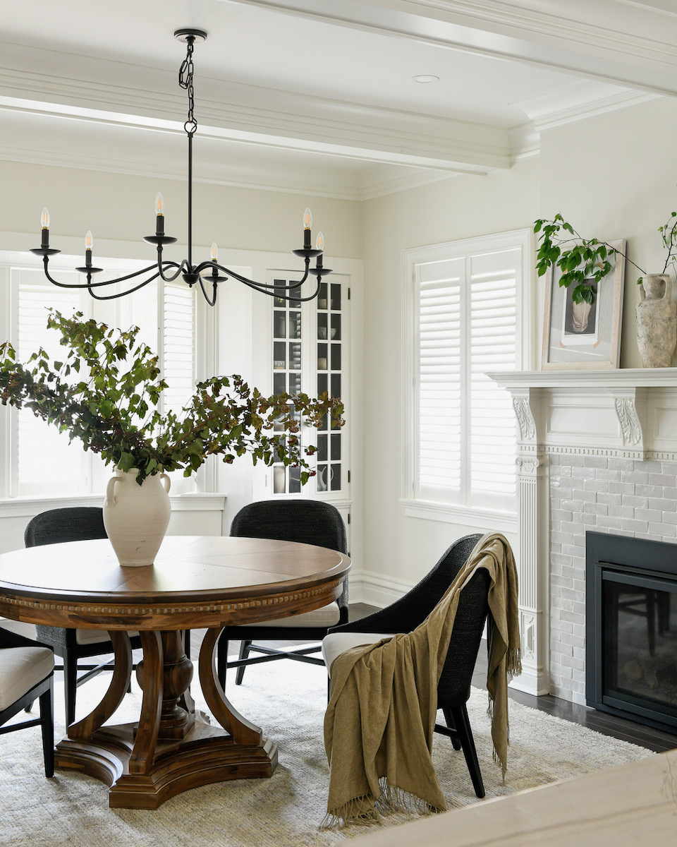 A dining table with some clothes draped over it