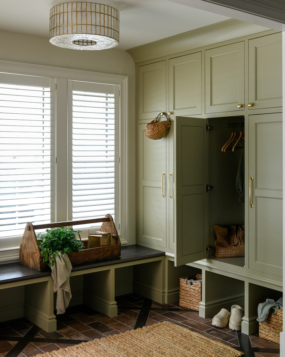 White cabinets, a picture window, and a shoe storage area 