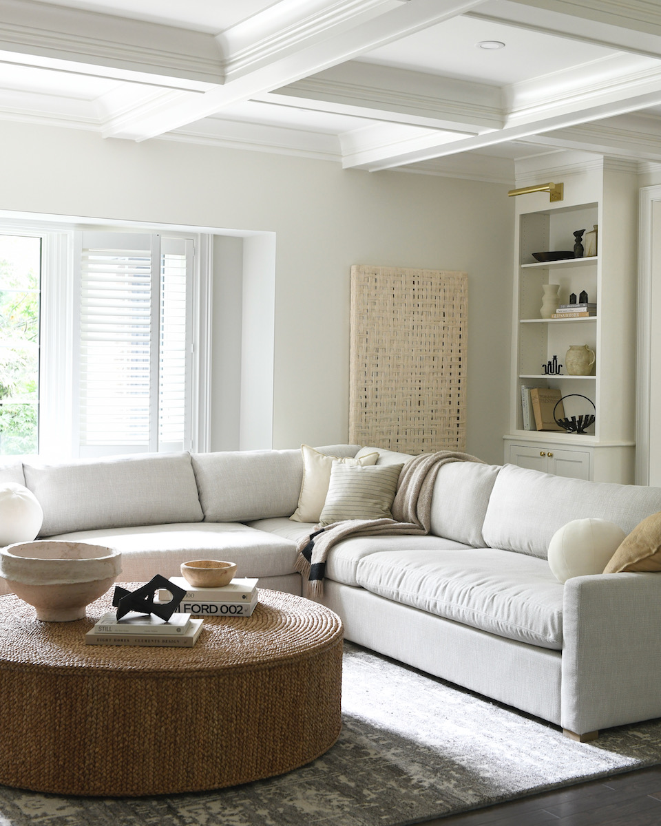 A white couch and wooden island 