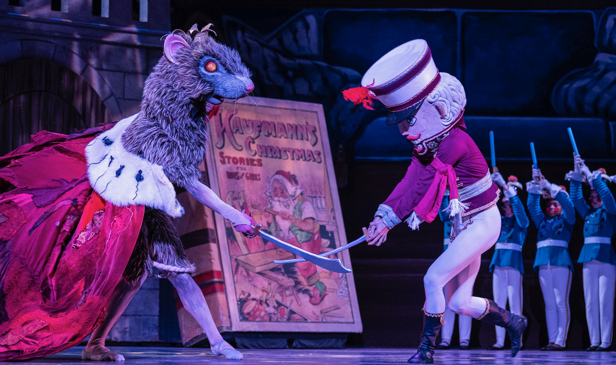 A rat and the nutcracker dance in the ballet of The Nutcracker