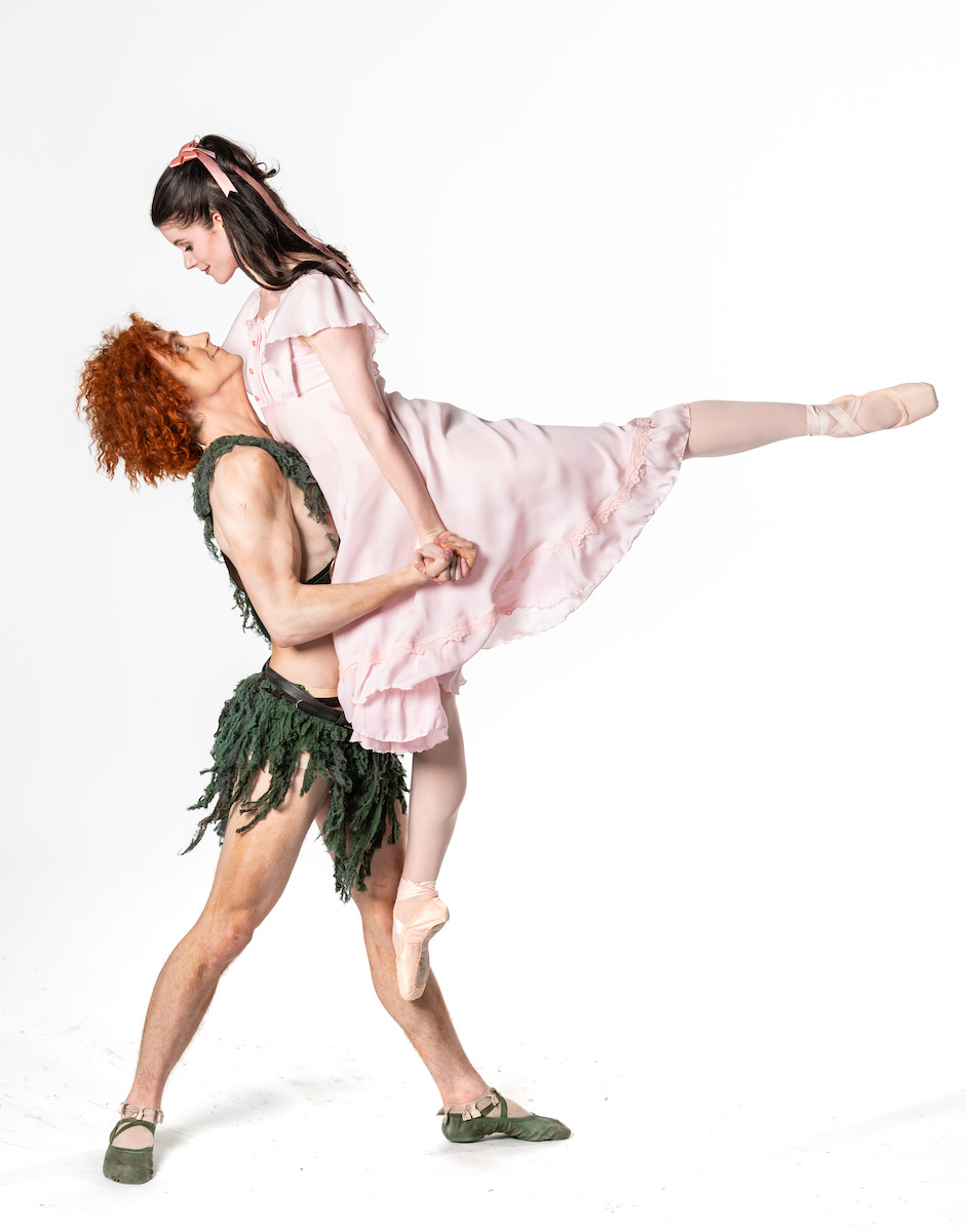 Peter Pan lifts Wendy into the air, her leg lifted for a ballet jump