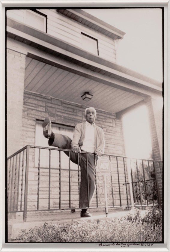 Teenie Harris makes a high kick over the fence in front of his Pittsburgh home