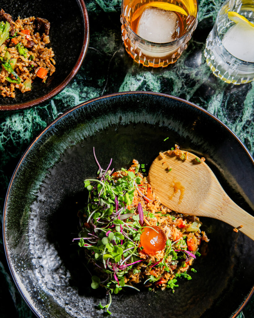 A bowl of food with a wooden spoon in it.