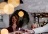 The Ultimate Guide to Christmas Entertaining A group of people cheers champagne glasses over a table.