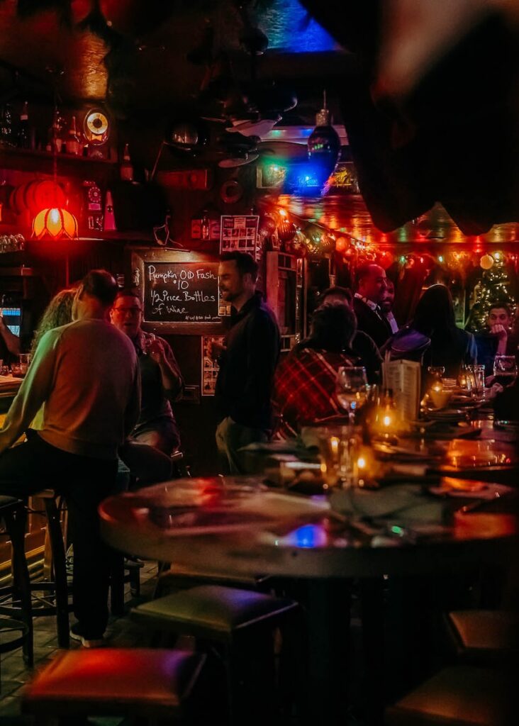 People talk and drink in the bar space of Carmella's Plates and Pints.