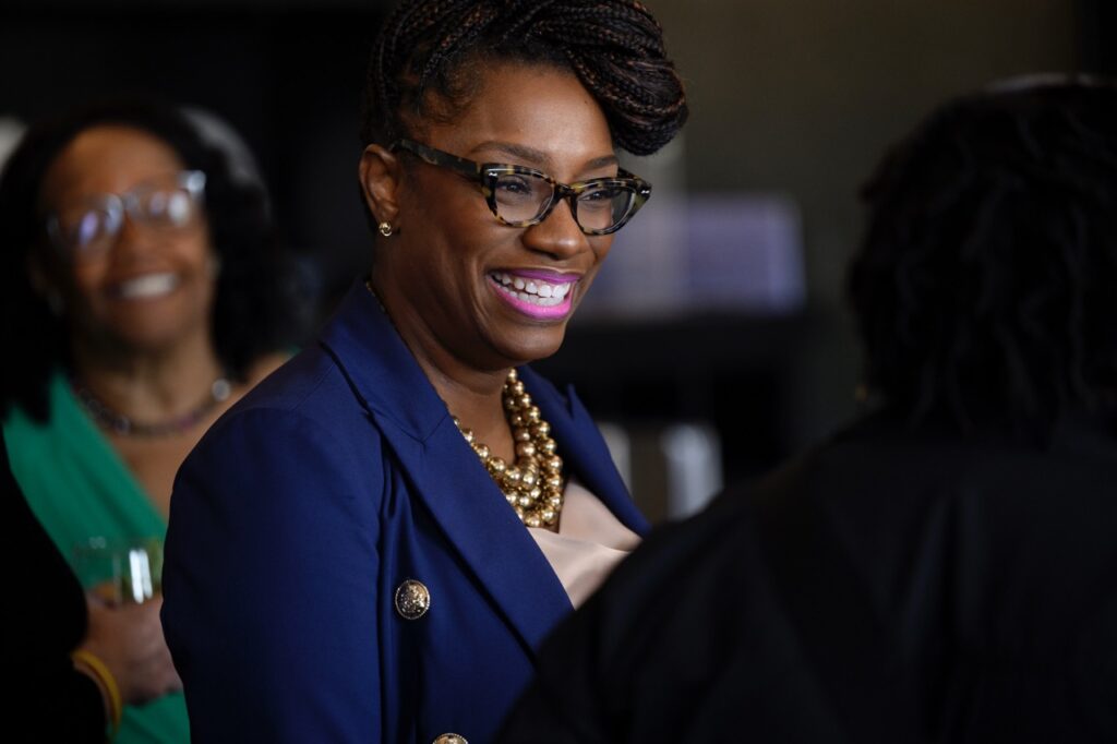 A woman in a blue jacket speaks to a nonprofit roundtable in Pittsburgh.