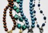 Discover Timeless Elegance: Larrimor’s Jewelry Collection Four beaded necklaces with pendants laying flat on a white background at Larrimor's.