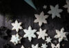 50 Holiday Dessert Recipes to Satisfy Your Festive Sweet Tooth Sugar cookies shaped like snowflakes on a black background!