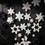 Sugar cookies shaped like snowflakes on a black background!