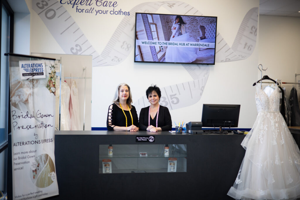 Two women standing behind the counter at The Bridal Hub in Warrendale.