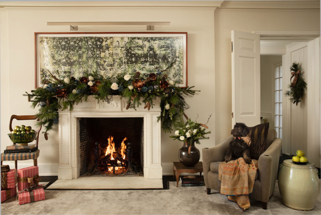 A Christmas tree set in a large, beige parlor in an upscale home