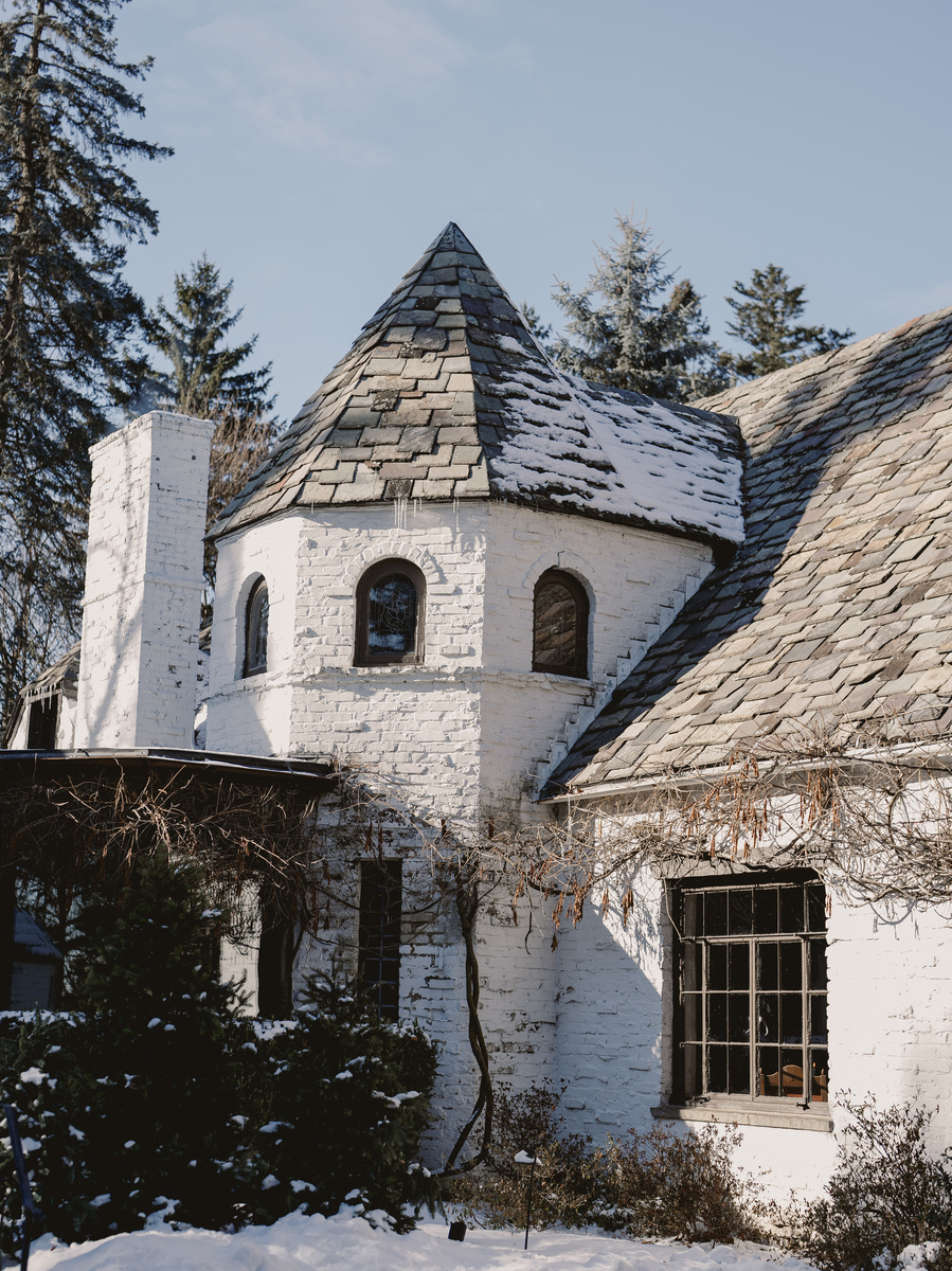 Snow-dusted roof of historic home provides picturesque backdrop for Italian Christmas feast.