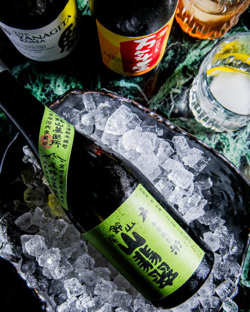 A close-up of a wine bottle, placed on a bed of crushed ice.