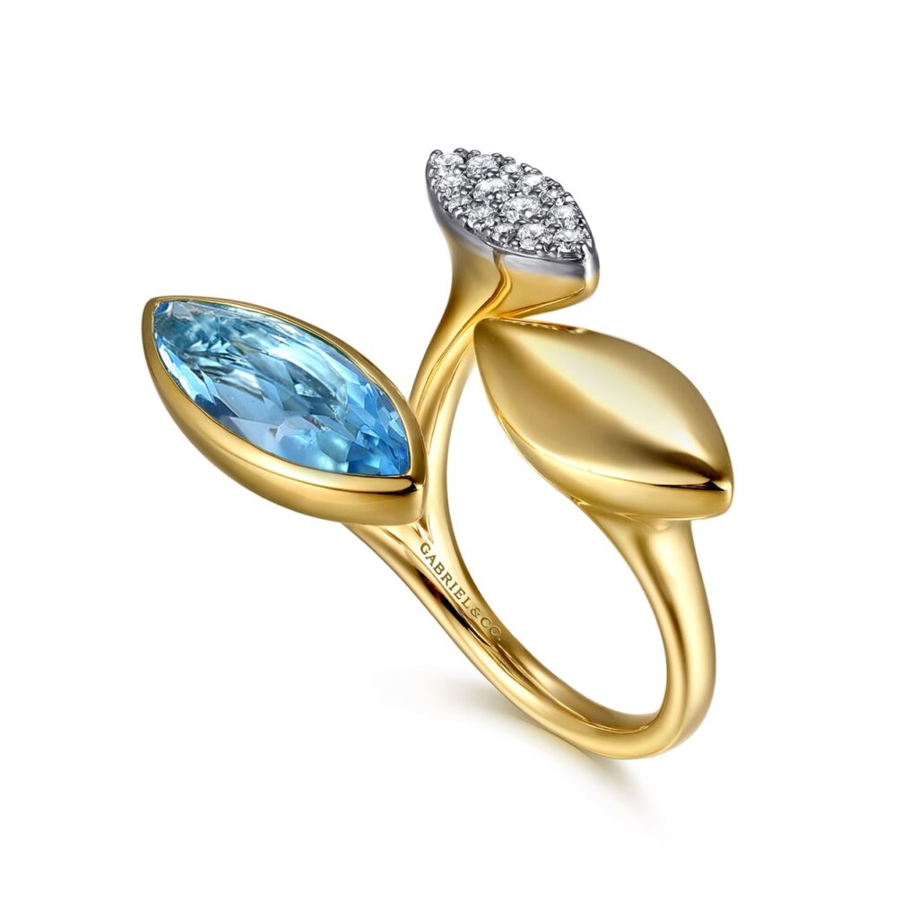 A gold ring with a blue and silver jewel.