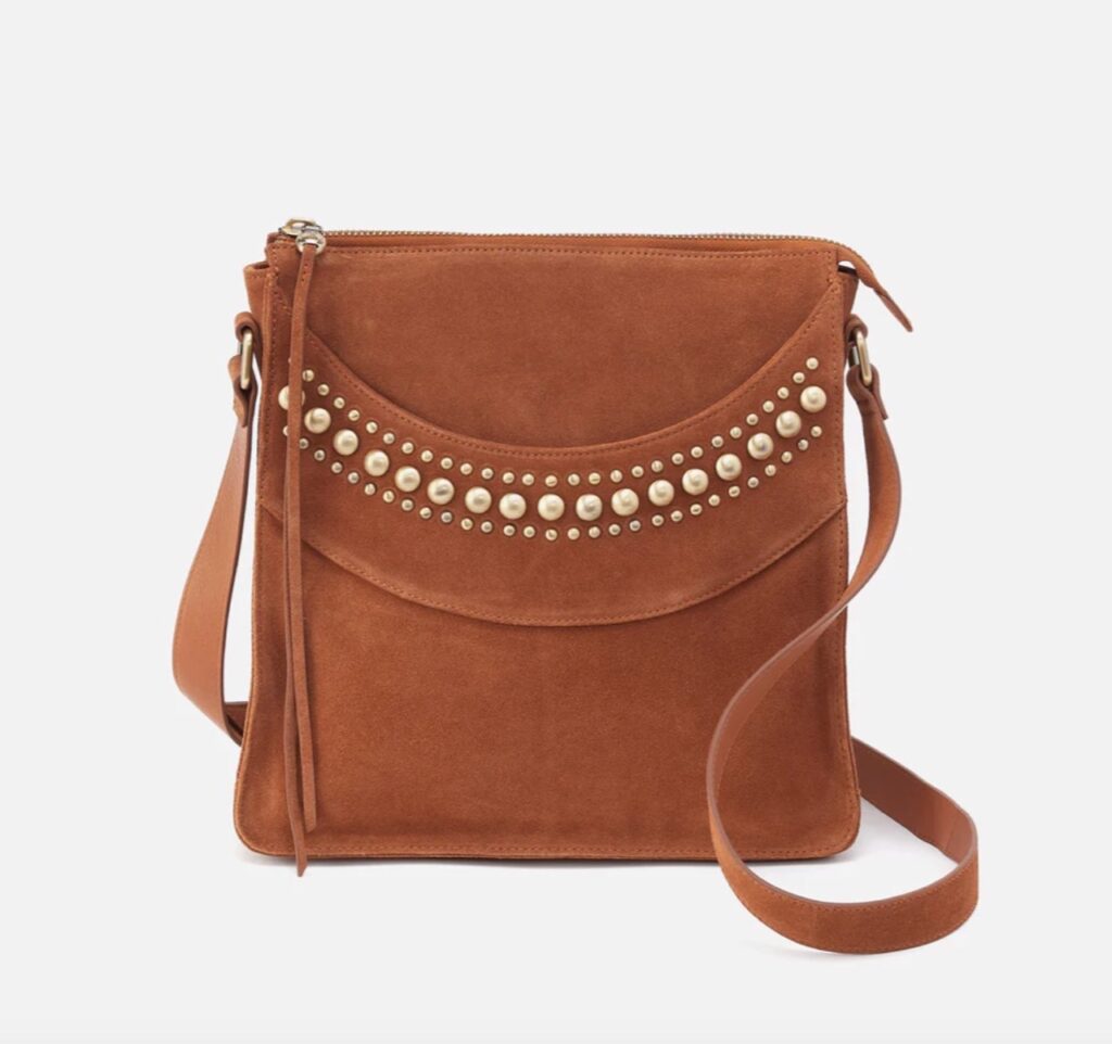 A suede bag in brown with studs on the front.