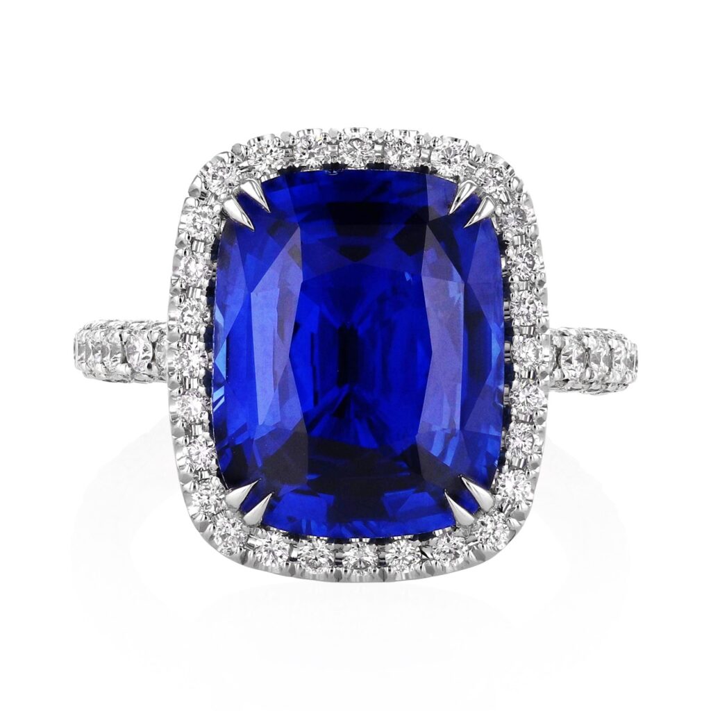 A blue sapphire ring with silver jewels around it.