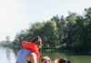 Giving Guide 2024: Easterseals A woman in a life vest helps a boy in a wheelchair get his life vest on while on a wooden dock.