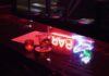 Best Solo Dining Spots in Pittsburgh The neon sign of Fet-Fisk's bar above two glasses on a dimly lit bar counter