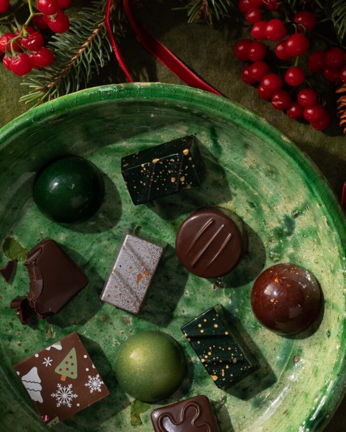 Various small chocolates on a green plate.