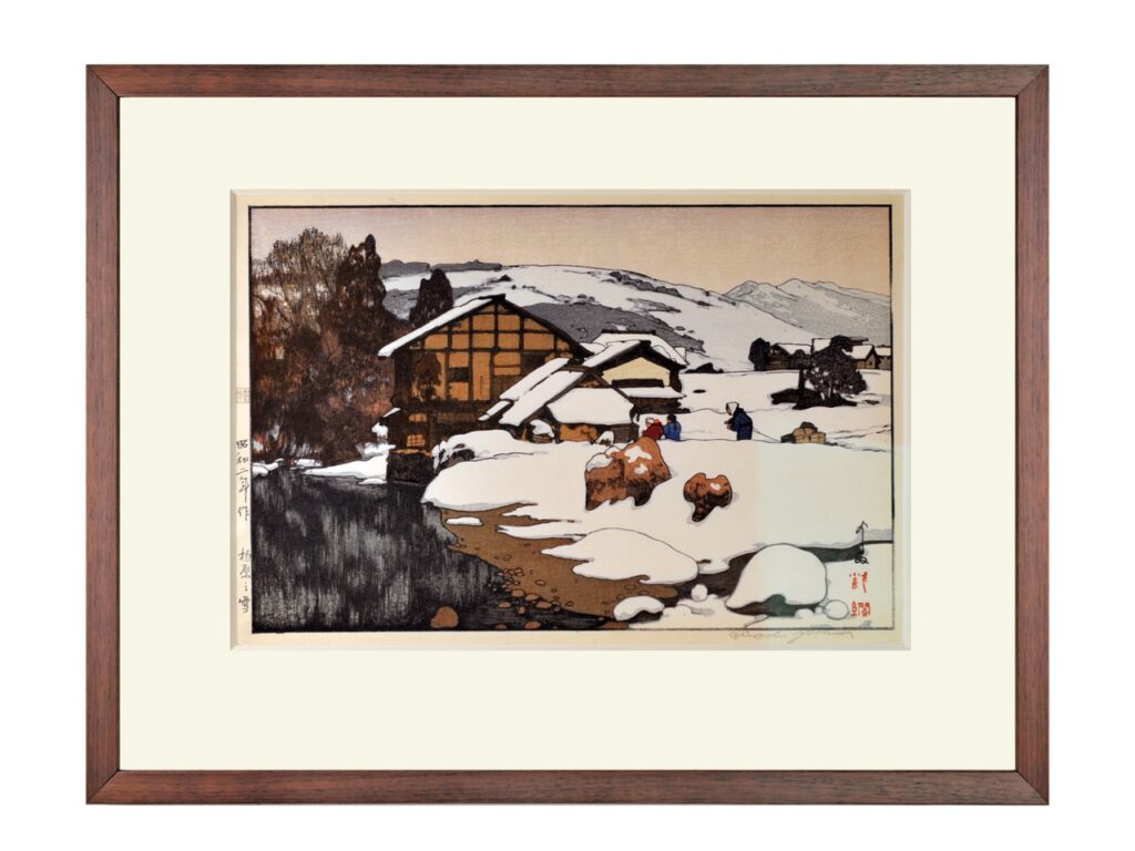 A painting of a winter cabin and scene in a frame.