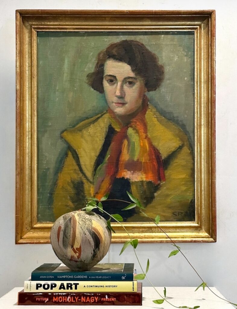 A portrait of a person in a yellow coat hanging on a wall.