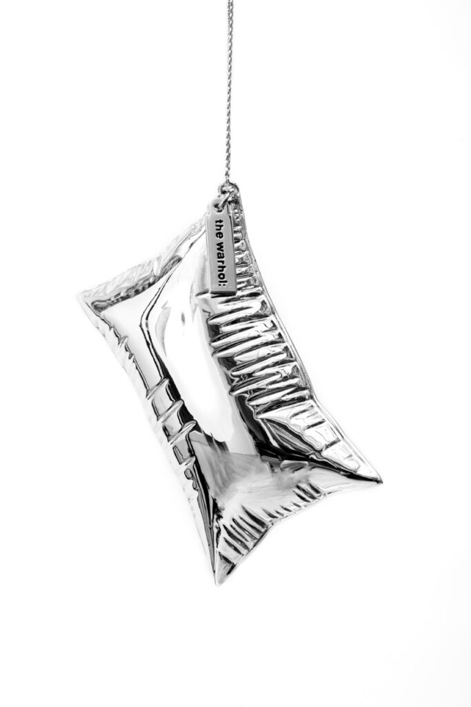A silver balloon ornament hangs from a string.