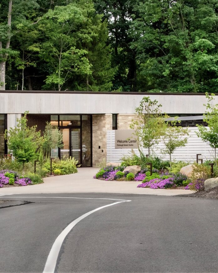 A road leading to a welcome center for Pittsburgh Botanic Garden.