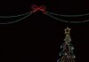 5 Pittsburgh Events This Week (November 25-December 2) On a black background of a stage in Pittsburgh is the outline of a Christmas tree in neon lights as well as two soldiers in neon lights playing keyboards.