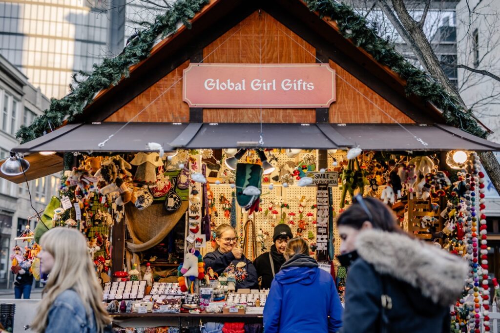 People browse at Global Girl Gifts in the outside Pittsburgh holiday market.